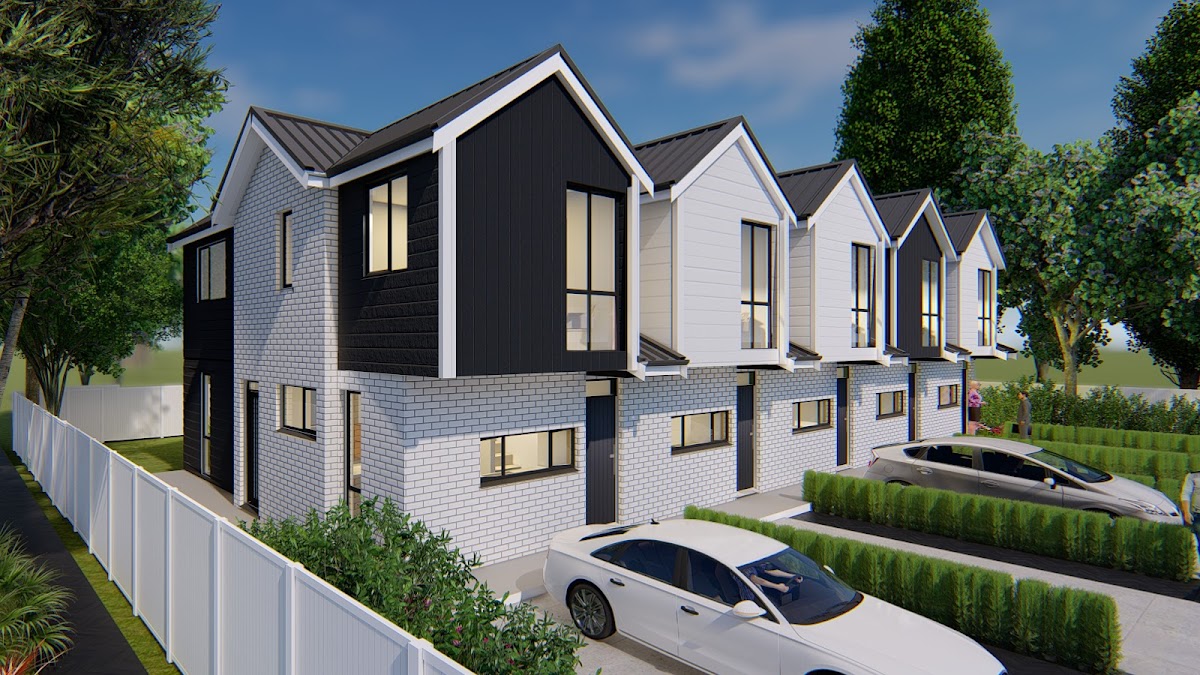 A completed Ashcroft Homes terrace development in Auckland at dusk, four gabled homes in white weatherboard and charcoal brick.