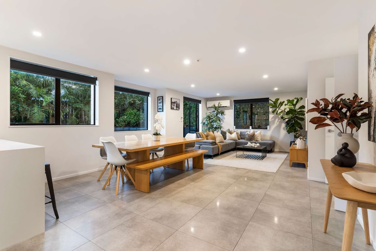 Interior of a completed Ashcroft Homes living and dining space with large windows and open plan layout.
